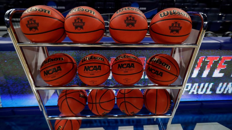 Game balls are displayed on a rack before a regional championship game between Notre Dame and...