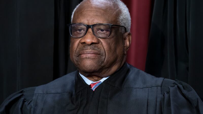FILE - Associate Justice Clarence Thomas joins other members of the Supreme Court as they pose...