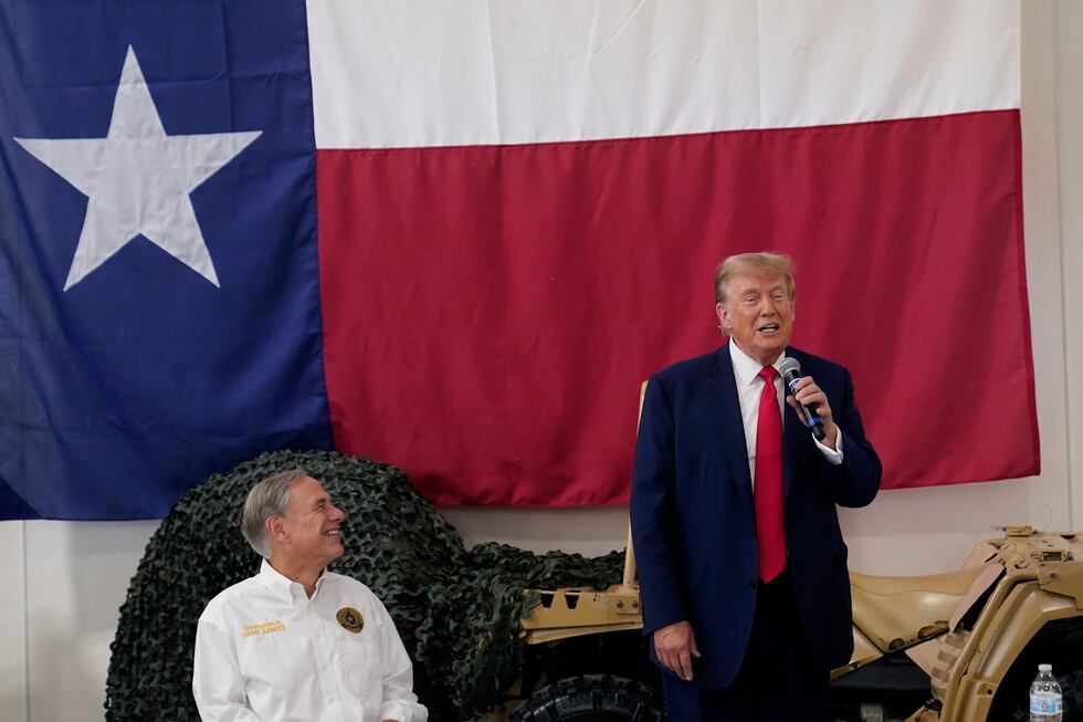 Texas Gov. Greg Abbott, left, listens as Republican presidential candidate and former...
