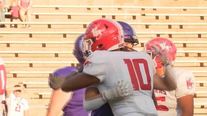 Perryton and Canyon players embrace after intentional delay of game penalty to honor community...