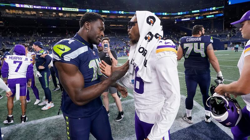 Seattle Seahawks wide receiver DK Metcalf, left, talks with Minnesota Vikings wide receiver...